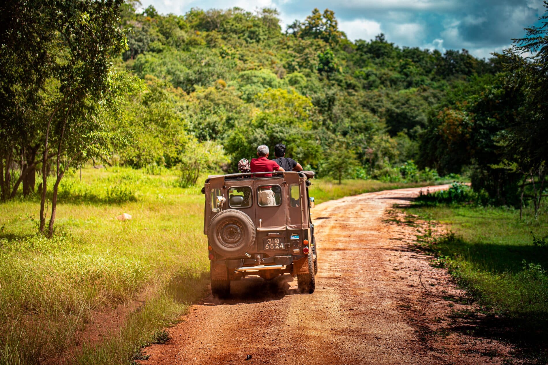 Safari jeep on a dirt road through the national park